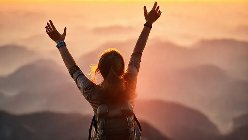 A photorealistic, professional photography shot of a solo female traveler (30s, diverse ethnicity) standing victoriously at a mountain summit, arms raised in celebration, gazing at a panoramic view. The sun is setting, casting a warm glow. Sharp focus on her joyful expression and silhouette, with the vast, blurred mountain range in the background. Cinematic lighting, depth of field, 8K hyper-detailed, shot on a high-end DSLR, conveying a powerful sense of accomplishment and self-worth. A photorealistic, professional photography shot of a solo female traveler (30s, diverse ethnicity) standing victoriously at a mountain summit, arms raised in celebration, gazing at a panoramic view. The sun is setting, casting a warm glow. Sharp focus on her joyful expression and silhouette, with the vast, blurred mountain range in the background. Cinematic lighting, depth of field, 8K hyper-detailed, shot on a high-end DSLR, conveying a powerful sense of accomplishment and self-worth.