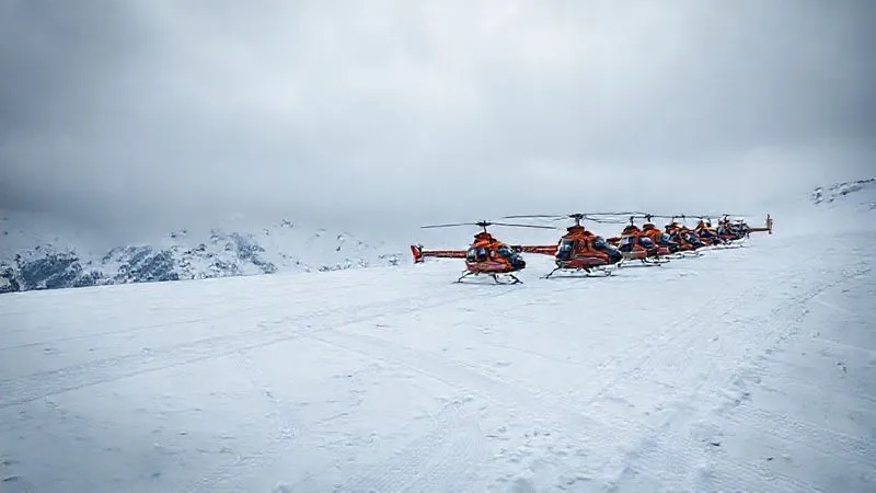A photorealistic image of a line of multiple heli-skiing helicopters waiting at a single drop zone, with numerous ski tracks already visible on the slope below, conveying a sense of crowding and lost solitude. Overcast dramatic lighting, sharp focus, 8K hyper-detailed. A photorealistic image of a line of multiple heli-skiing helicopters waiting at a single drop zone, with numerous ski tracks already visible on the slope below, conveying a sense of crowding and lost solitude. Overcast dramatic lighting, sharp focus, 8K hyper-detailed.