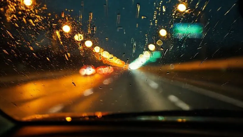 photorealistic, professional photography, 8K, cinematic lighting, sharp focus, depth of field, shot on a high-end DSLR. A driver's blurred perspective through a car windshield at night, rain streaks on the glass, highway lights creating long, distorted reflections, conveying a sense of disorientation and fatigue. photorealistic, professional photography, 8K, cinematic lighting, sharp focus, depth of field, shot on a high-end DSLR. A driver's blurred perspective through a car windshield at night, rain streaks on the glass, highway lights creating long, distorted reflections, conveying a sense of disorientation and fatigue.