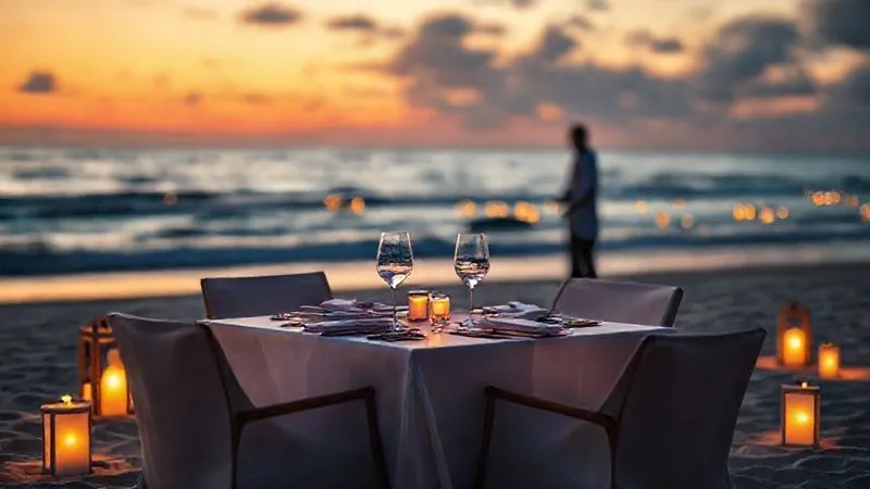 Photorealistic, professional photography, 8K, cinematic lighting, sharp focus, depth of field, shot on a high-end DSLR, a beautifully set private dining table for two on a secluded beach at sunset, surrounded by soft glowing lanterns and gentle waves, with a dedicated but discreet waiter in the background, emphasizing exclusivity, romance, and undisturbed intimacy. Photorealistic, professional photography, 8K, cinematic lighting, sharp focus, depth of field, shot on a high-end DSLR, a beautifully set private dining table for two on a secluded beach at sunset, surrounded by soft glowing lanterns and gentle waves, with a dedicated but discreet waiter in the background, emphasizing exclusivity, romance, and undisturbed intimacy.