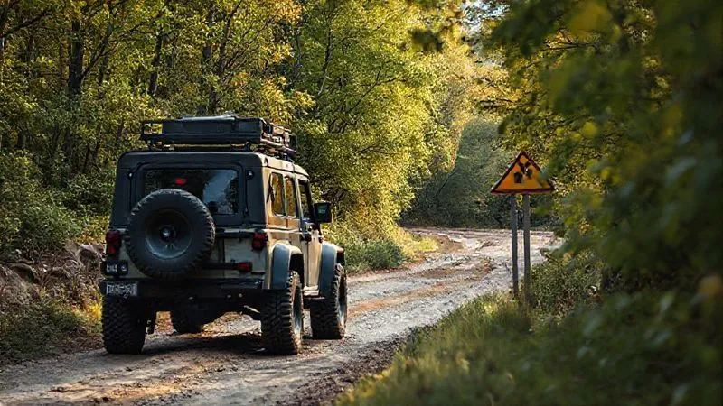 A rugged off-road vehicle navigating a challenging, scenic route, with a small, almost hidden legal warning sign partially obscured by foliage. The scene is photorealistic, professional photography, 8K, cinematic lighting, sharp focus, depth of field, shot on a high-end DSLR. A rugged off-road vehicle navigating a challenging, scenic route, with a small, almost hidden legal warning sign partially obscured by foliage. The scene is photorealistic, professional photography, 8K, cinematic lighting, sharp focus, depth of field, shot on a high-end DSLR.