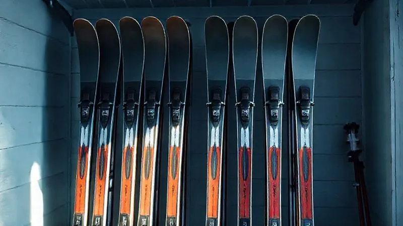 A photorealistic image of cross-country skis neatly stored on a rack in a cool, dry ski room, with a thick layer of storage wax visible on the bases, illuminated by soft, natural light. Professional photography, 8K, cinematic lighting, sharp focus on the skis, depth of field, shot on a high-end DSLR. A photorealistic image of cross-country skis neatly stored on a rack in a cool, dry ski room, with a thick layer of storage wax visible on the bases, illuminated by soft, natural light. Professional photography, 8K, cinematic lighting, sharp focus on the skis, depth of field, shot on a high-end DSLR.