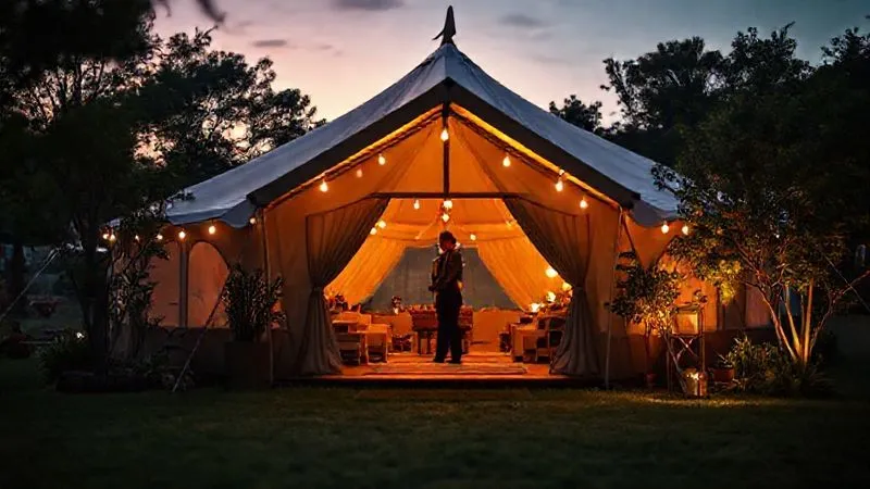 Photorealistic, professional photography, 8K, cinematic lighting, sharp focus on a luxurious, private glamping tent entrance at dusk, with subtle, discreet security personnel in the background, surrounded by lush, well-maintained natural elements. Depth of field blurs the festival activity beyond the private area. Shot on a high-end DSLR, conveying exclusivity and tranquility. Photorealistic, professional photography, 8K, cinematic lighting, sharp focus on a luxurious, private glamping tent entrance at dusk, with subtle, discreet security personnel in the background, surrounded by lush, well-maintained natural elements. Depth of field blurs the festival activity beyond the private area. Shot on a high-end DSLR, conveying exclusivity and tranquility.