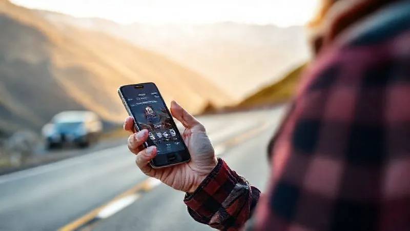 A photorealistic, professional photography image of a traveler on a scenic mountain road, confidently holding a phone with a roadside assistance app open, a modern car visible in the background, cinematic lighting, sharp focus on the phone and traveler, depth of field blurring the distant mountains, 8K hyper-detailed. A photorealistic, professional photography image of a traveler on a scenic mountain road, confidently holding a phone with a roadside assistance app open, a modern car visible in the background, cinematic lighting, sharp focus on the phone and traveler, depth of field blurring the distant mountains, 8K hyper-detailed.