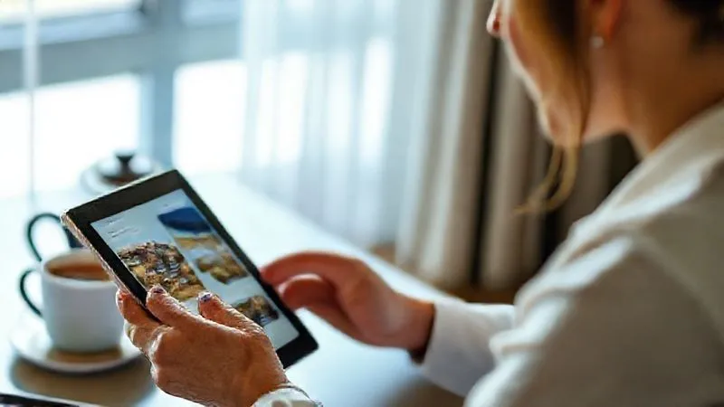 Photorealistic professional photography of an executive thoughtfully using a tablet to research wellness resorts, with a serene, organized workspace and a cup of herbal tea. The screen displays diverse resort options, implying careful consideration and personalized choice. Soft, natural light, sharp focus on the tablet and executive's hands, depth of field blurring the background. 8K hyper-detailed, cinematic lighting. Photorealistic professional photography of an executive thoughtfully using a tablet to research wellness resorts, with a serene, organized workspace and a cup of herbal tea. The screen displays diverse resort options, implying careful consideration and personalized choice. Soft, natural light, sharp focus on the tablet and executive's hands, depth of field blurring the background. 8K hyper-detailed, cinematic lighting.